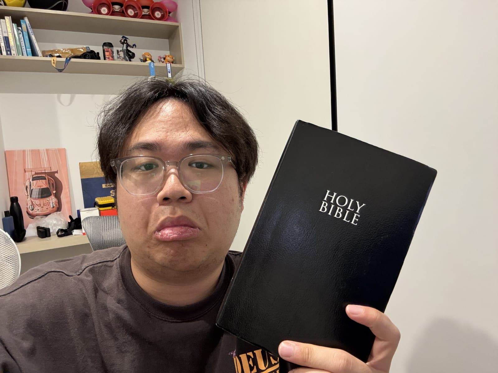 Me holding up my black Holy Bible